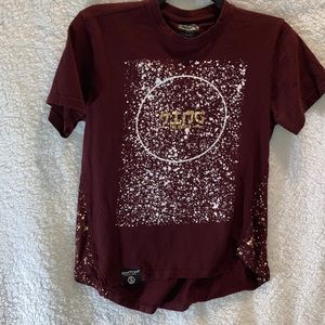 A maroon shirt with a white facing short sleeve